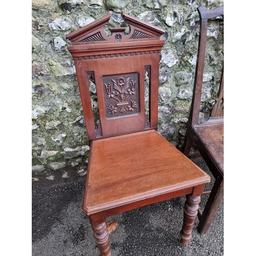 1131 - An 18th century oak dining chair; together with a circa 1900 carved mahogany hall chair; and an... 