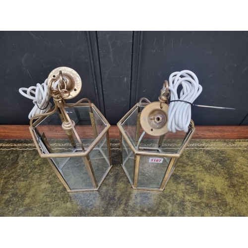 1187 - A pair of brass hexagonal ceiling lanterns, 35cm high. (2)