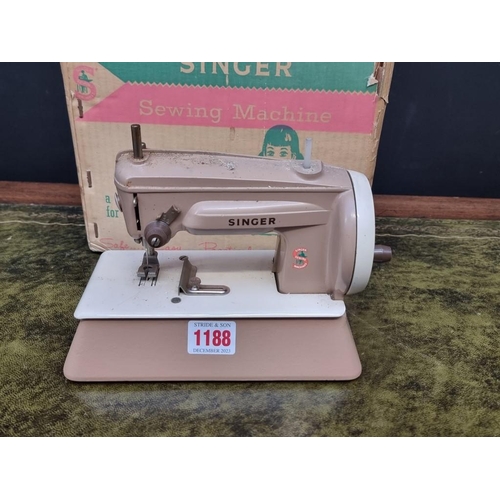 1188 - A vintage Singer child's sewing machine, in card box. 