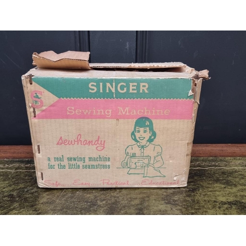 1188 - A vintage Singer child's sewing machine, in card box. 