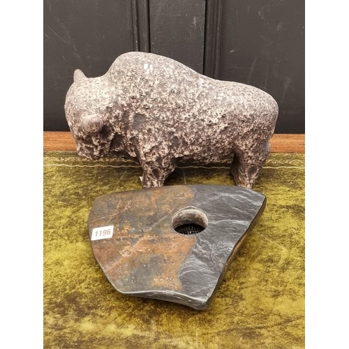 1196 - A pottery bison, 32cm long; together with a slate candleholder, 27cm wide. (2) ... 