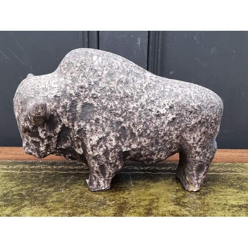 1196 - A pottery bison, 32cm long; together with a slate candleholder, 27cm wide. (2) ... 