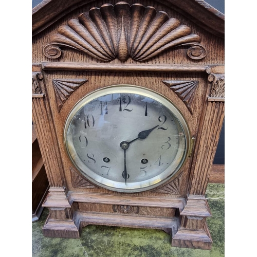 1201 - Two oak mantel clocks, largest 37.5cm high, each with pendulum. 