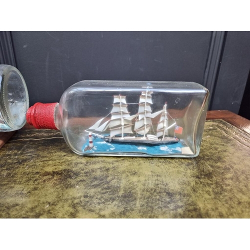 1206 - Five ships in glass bottles, largest 32.5cm long. 