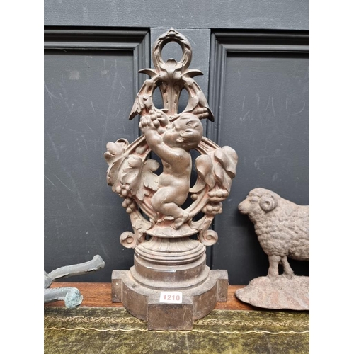 1210 - A cast iron cherub and fruiting vine doorstop, possibly Coalbrookdale; together with another cast ir... 