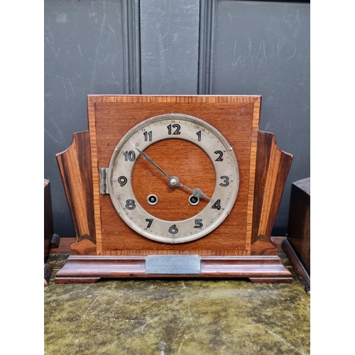 1225 - A 1930s mahogany and inlaid mantel clock, 29cm diameter; together with two further oak examples. (3)... 