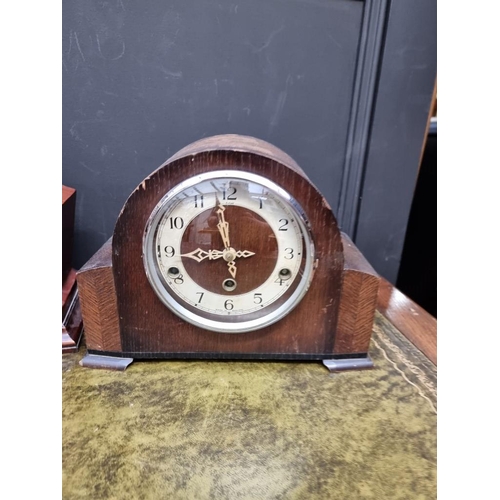 1225 - A 1930s mahogany and inlaid mantel clock, 29cm diameter; together with two further oak examples. (3)... 