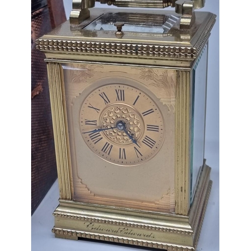 1445 - A good antique brass carriage clock, with push button repeat and gong strike, height including handl... 