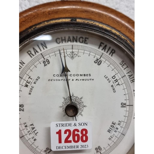 1268 - An oak aneroid barometer, 18cm diameter.