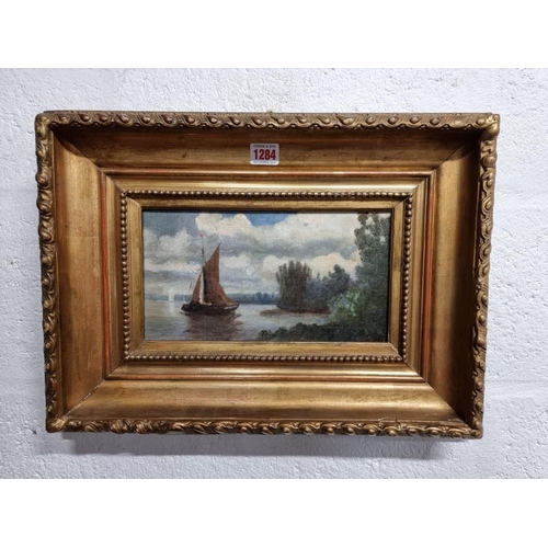 1284 - British School, sailing boat on a lake, oil on canvas, 15 x 28.5cm.