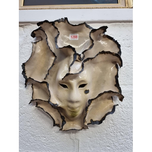 1288 - Studio Pottery: a wall mask by Frances Mace, 37cm high. 