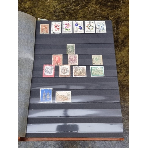 1313 - Stamps: a mixed world stock book; together with an early 20th century album of cigarette cards, to i... 