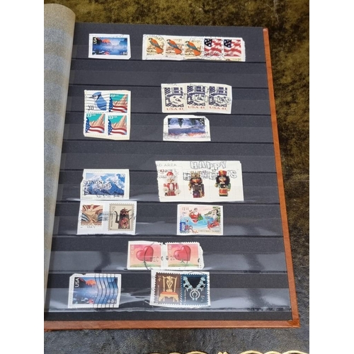 1313 - Stamps: a mixed world stock book; together with an early 20th century album of cigarette cards, to i... 