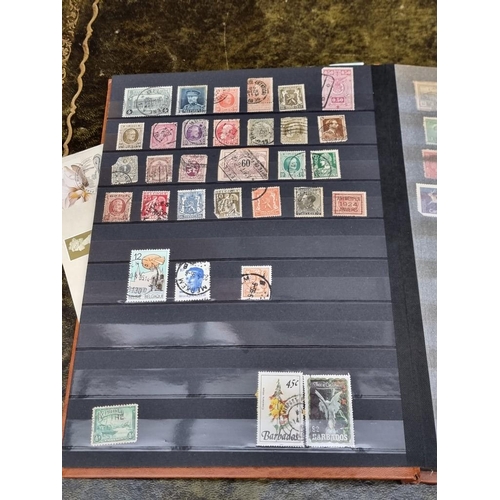 1313 - Stamps: a mixed world stock book; together with an early 20th century album of cigarette cards, to i... 