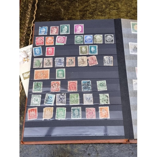 1313 - Stamps: a mixed world stock book; together with an early 20th century album of cigarette cards, to i... 