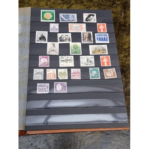 1313 - Stamps: a mixed world stock book; together with an early 20th century album of cigarette cards, to i... 