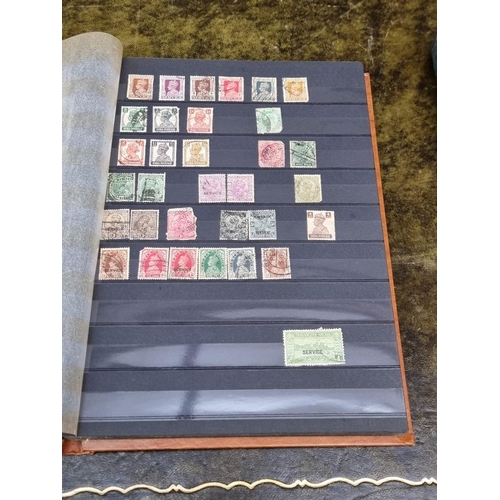 1313 - Stamps: a mixed world stock book; together with an early 20th century album of cigarette cards, to i... 