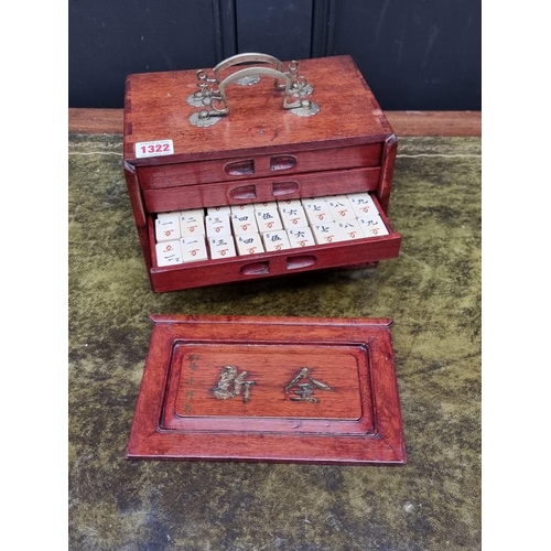 1322 - A Chinese hardwood cased bone and bamboo mahjong set. 