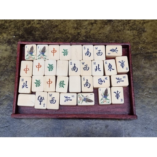 1322 - A Chinese hardwood cased bone and bamboo mahjong set. 