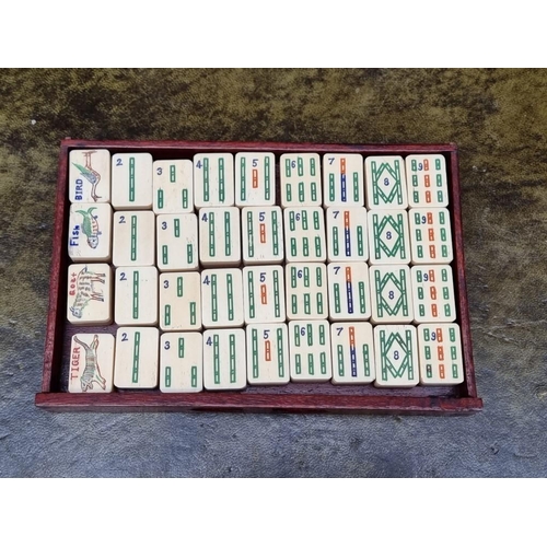 1322 - A Chinese hardwood cased bone and bamboo mahjong set. 