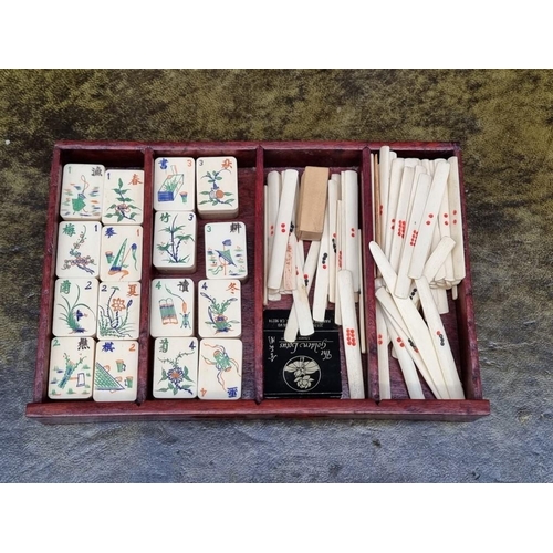 1322 - A Chinese hardwood cased bone and bamboo mahjong set. 