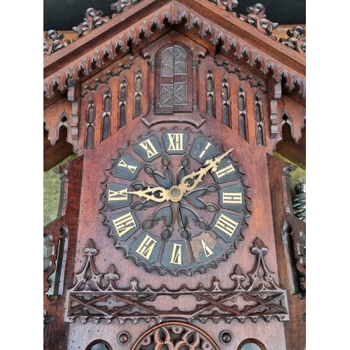 1339 - An unusual Black Forest carved walnut 'trumpeter' wall clock, 62.5cm high, (some old worm), with pen... 