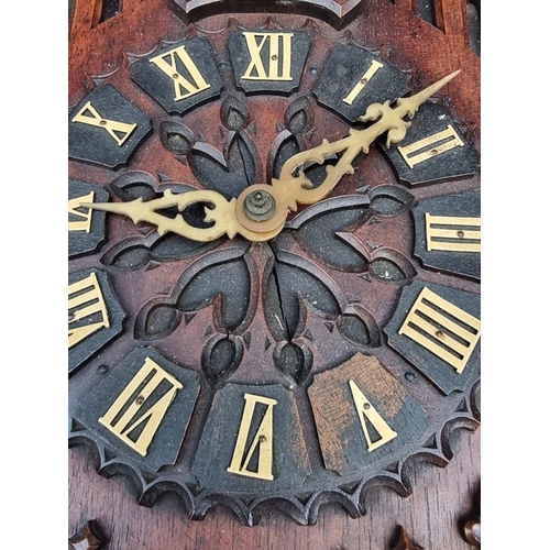 1339 - An unusual Black Forest carved walnut 'trumpeter' wall clock, 62.5cm high, (some old worm), with pen... 