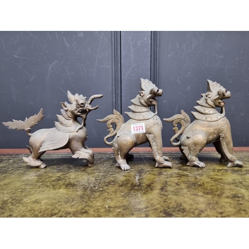 1371 - Three eastern bronze lion dogs, largest 20.5cm high. (3)