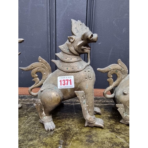 1371 - Three eastern bronze lion dogs, largest 20.5cm high. (3)