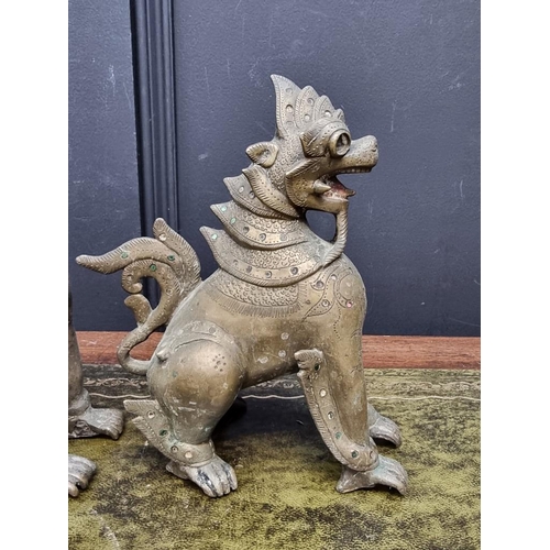 1371 - Three eastern bronze lion dogs, largest 20.5cm high. (3)