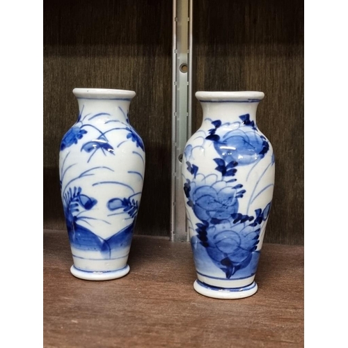 1386 - A collection Chinese and Japanese blue and white vases, largest 14cm high. (8)