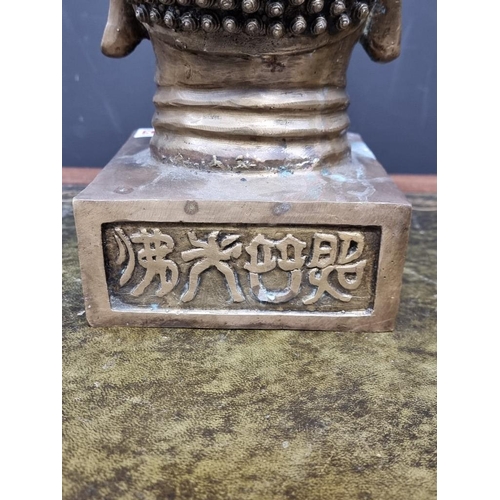 1393 - A Chinese brass Buddha's head, with archaistic seal marks, 33cm high.