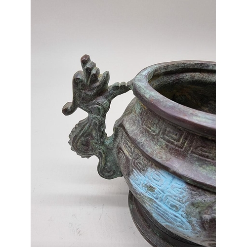 1476 - A Chinese bronze twin handled censer, in Archaistic style, 18cm wide.