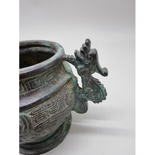 1476 - A Chinese bronze twin handled censer, in Archaistic style, 18cm wide.