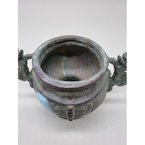 1476 - A Chinese bronze twin handled censer, in Archaistic style, 18cm wide.