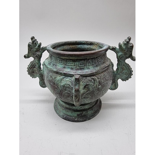 1476 - A Chinese bronze twin handled censer, in Archaistic style, 18cm wide.