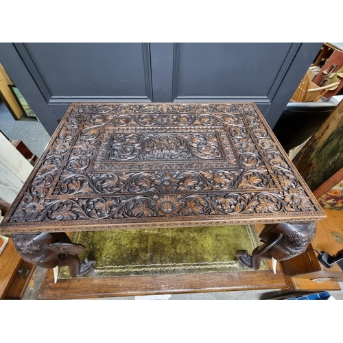 1022 - An Eastern carved hardwood rectangular low occasional table, with Elephant supports and bone decorat... 