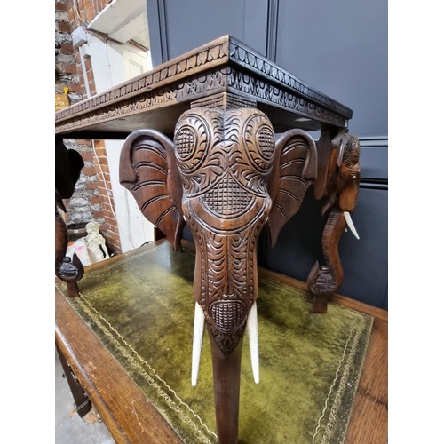 1022 - An Eastern carved hardwood rectangular low occasional table, with Elephant supports and bone decorat... 