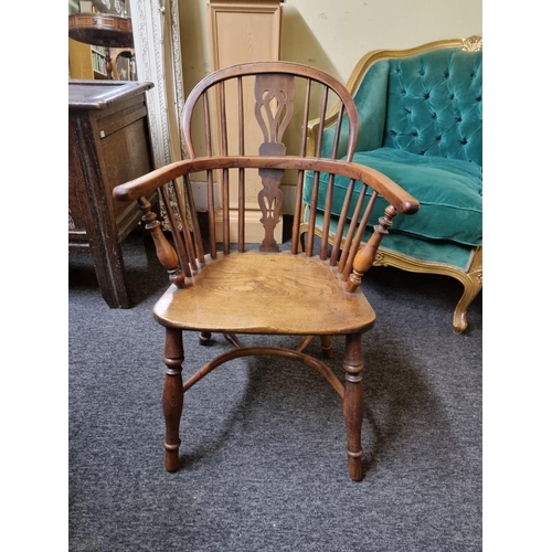 1070 - A 19th century yew and elm low back Windsor armchair, with crinoline stretcher, (slightly reduced in... 