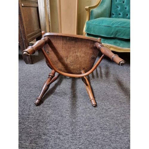 1070 - A 19th century yew and elm low back Windsor armchair, with crinoline stretcher, (slightly reduced in... 