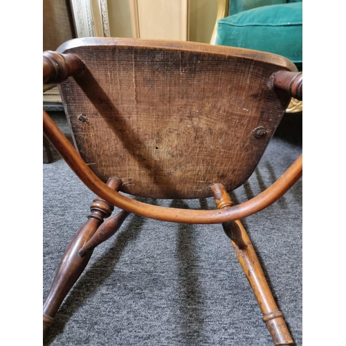 1070 - A 19th century yew and elm low back Windsor armchair, with crinoline stretcher, (slightly reduced in... 