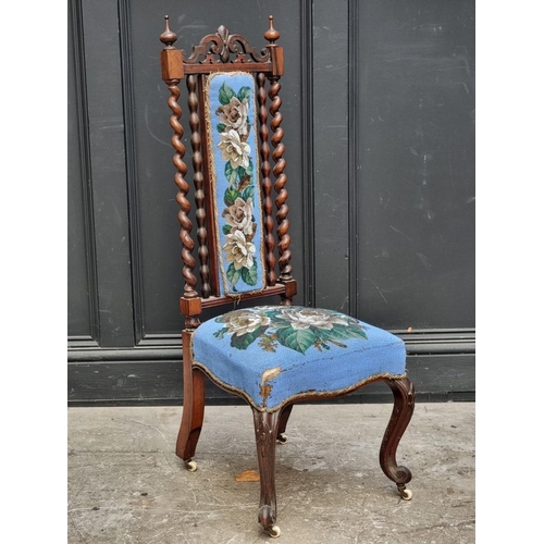 1071 - A small Victorian walnut and beadwork upholstered nursing chair, (s.d.).... 