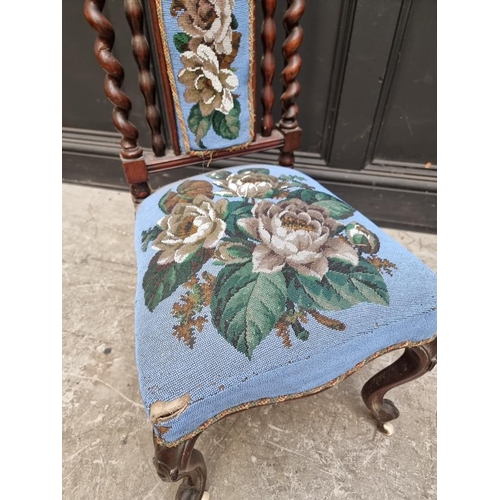 1071 - A small Victorian walnut and beadwork upholstered nursing chair, (s.d.).... 