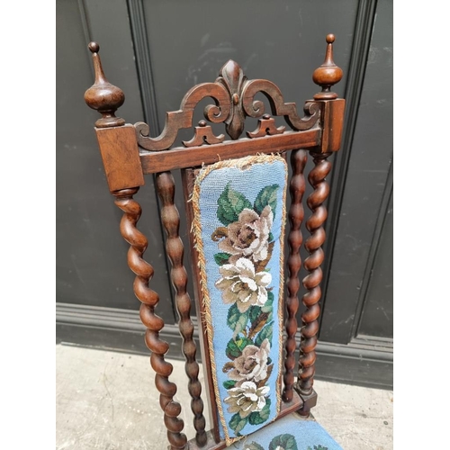 1071 - A small Victorian walnut and beadwork upholstered nursing chair, (s.d.).... 