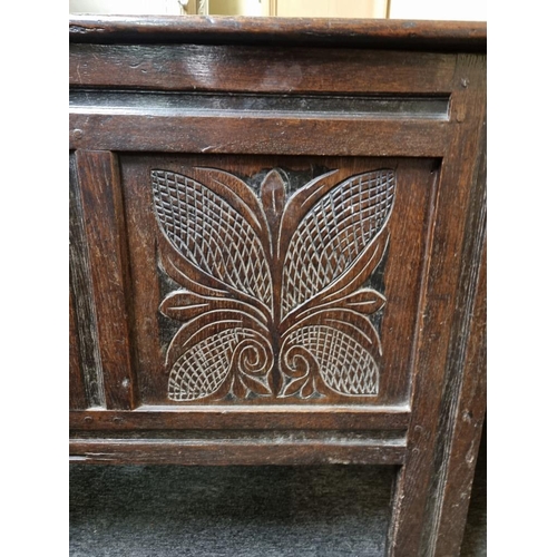 1105 - A late 17th century carved oak panelled coffer, 140cm wide.