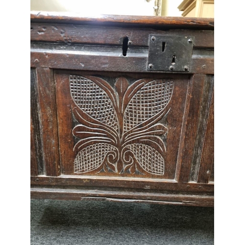 1105 - A late 17th century carved oak panelled coffer, 140cm wide.