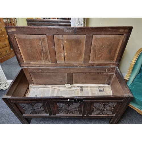 1105 - A late 17th century carved oak panelled coffer, 140cm wide.