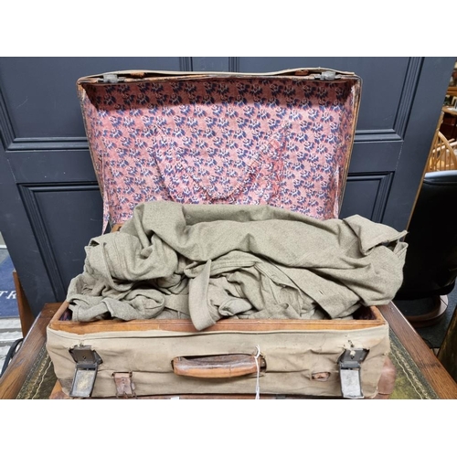 1235 - Two vintage tan leather suitcases, one with canvas cover, each containing military shirts and unifor... 