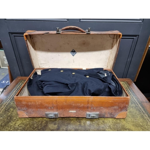 1235 - Two vintage tan leather suitcases, one with canvas cover, each containing military shirts and unifor... 