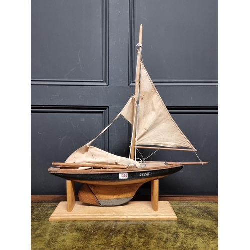 1344 - An old wood pond yacht, 63cm long, (sails distressed), on oak stand.